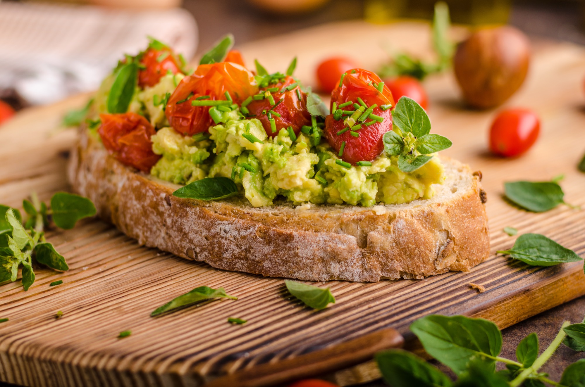 Avocado toast with blistered cherry tomatoes and fresh herbs