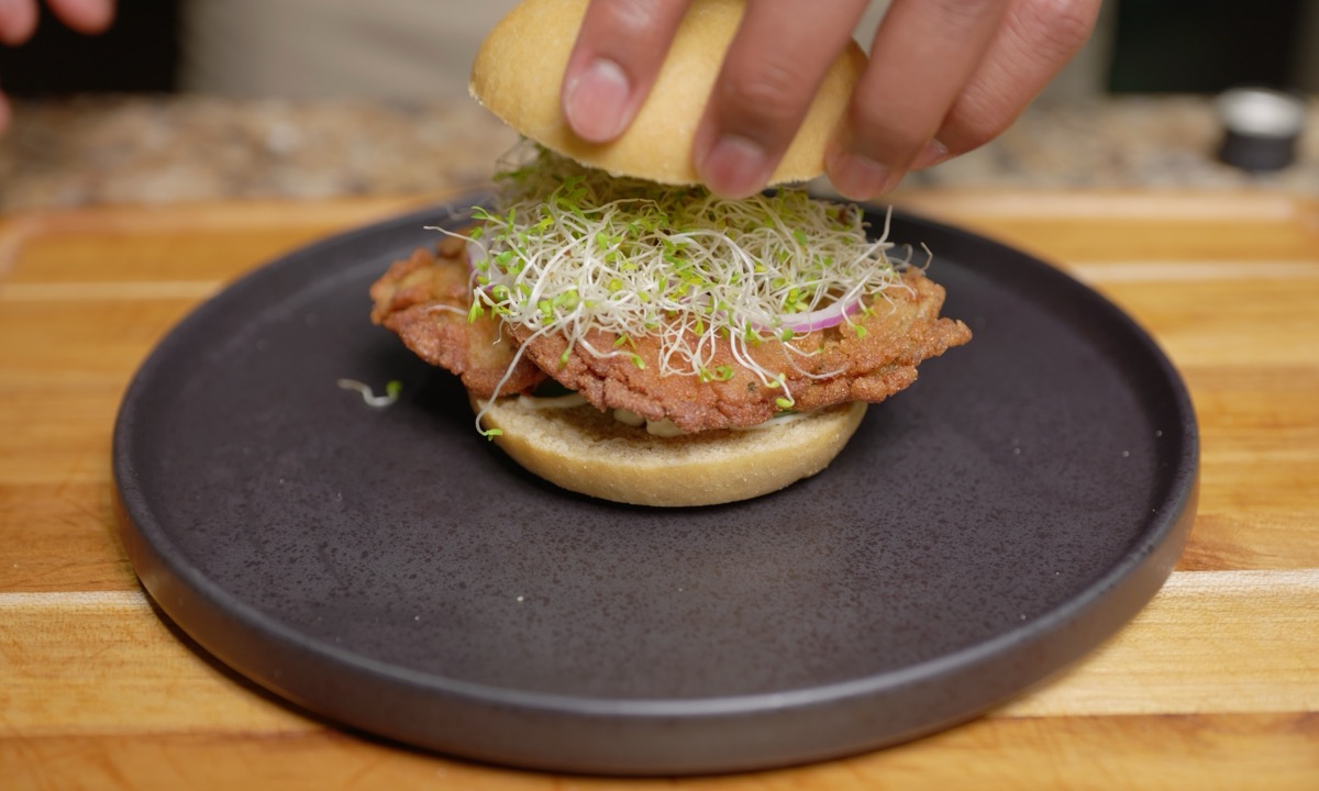 Crowning the sandwich — crispy oyster mushroom and alfalfa sprouts on a kamut bun