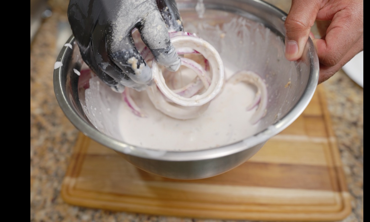 Floured onion rings dipped into coconut milk
